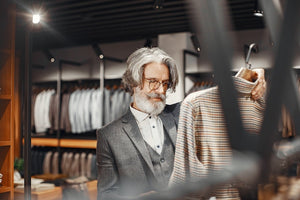 Aged man looking at a suit